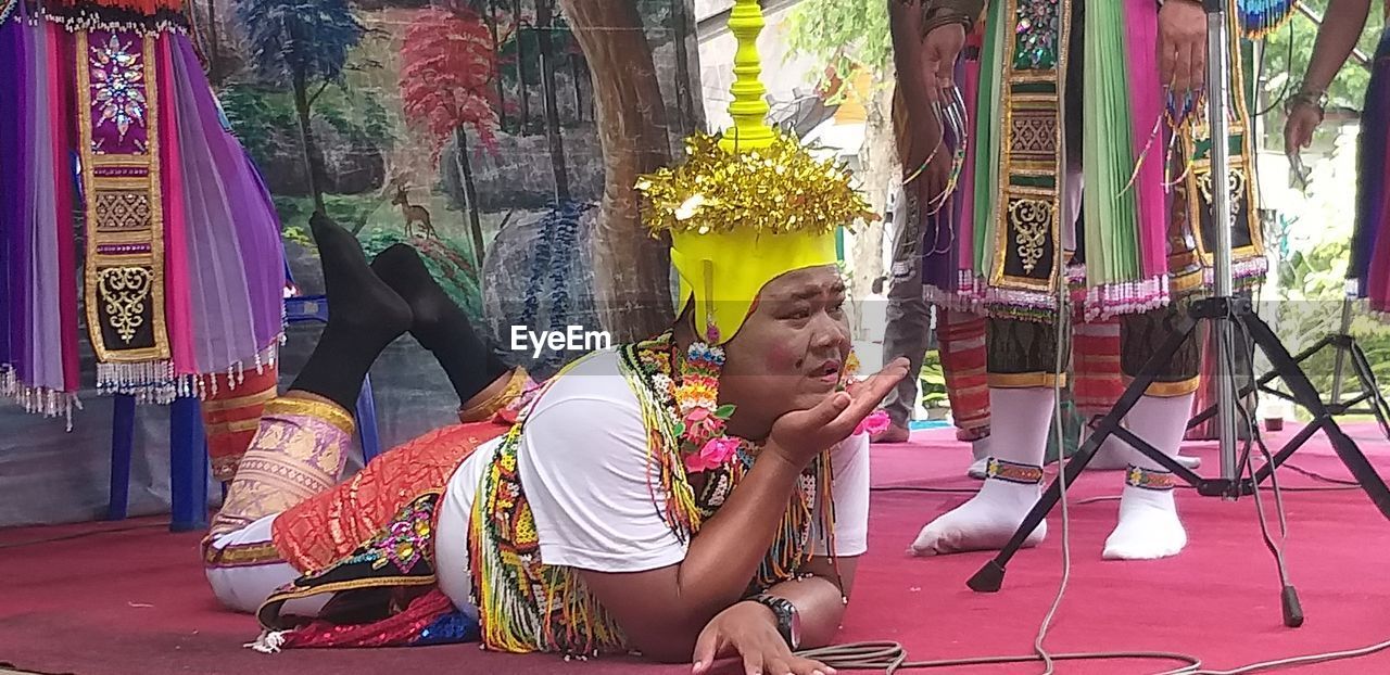 WOMAN SITTING IN TRADITIONAL CLOTHING