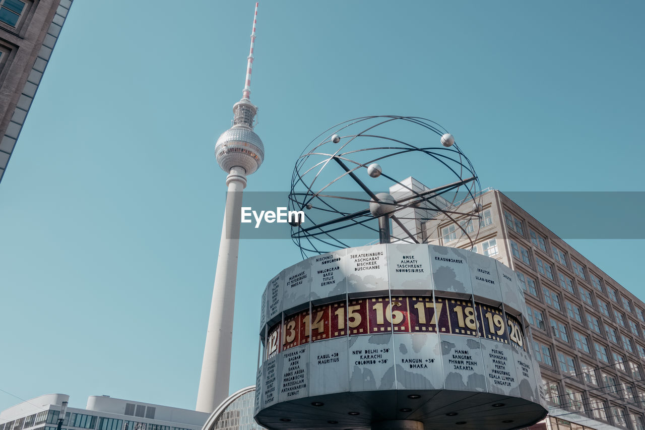 Low angle view of communications tower against sky