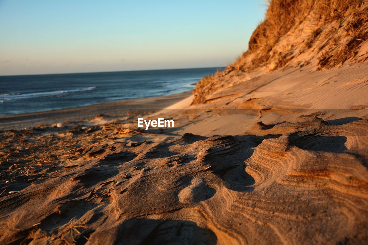 View of sandy beach against clear sky