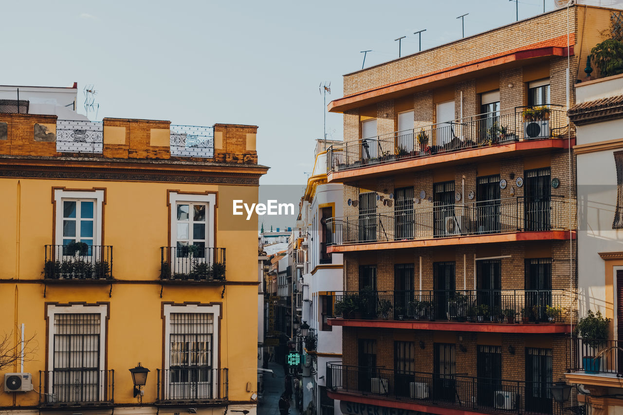 Traditional colourful buildings with balconies on a street in seville, spain.