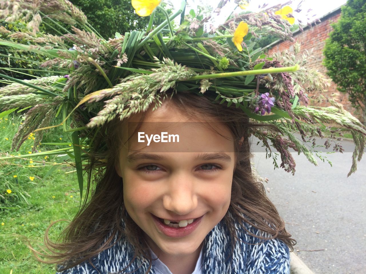 Close-up of portrait of smiling girl wearing flowers