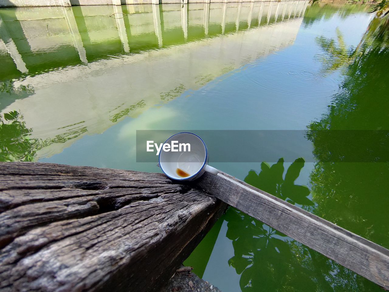 HIGH ANGLE VIEW OF COFFEE WITH REFLECTION ON RAILING