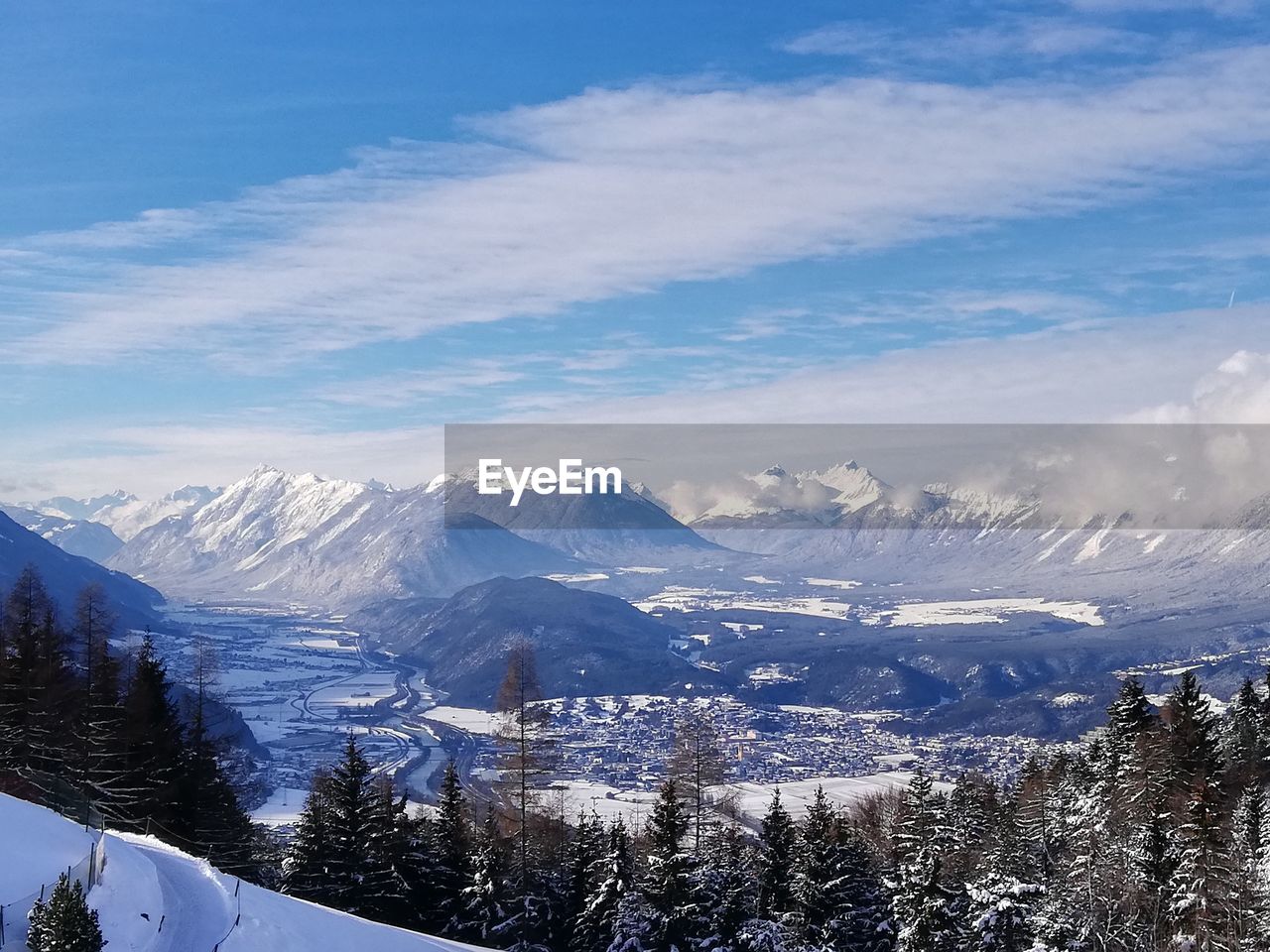 AERIAL VIEW OF SNOWCAPPED MOUNTAINS AGAINST SKY