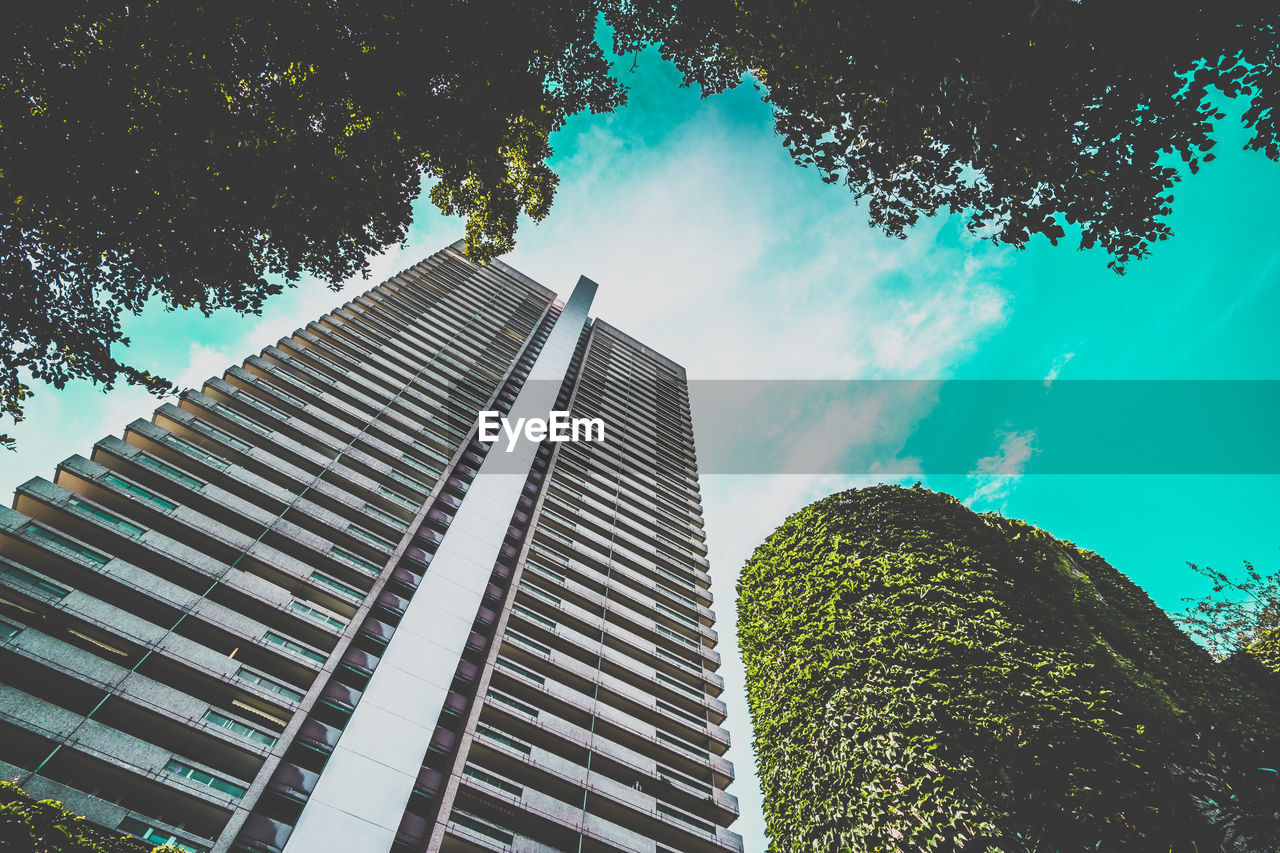 Low angle view of modern building against blue sky