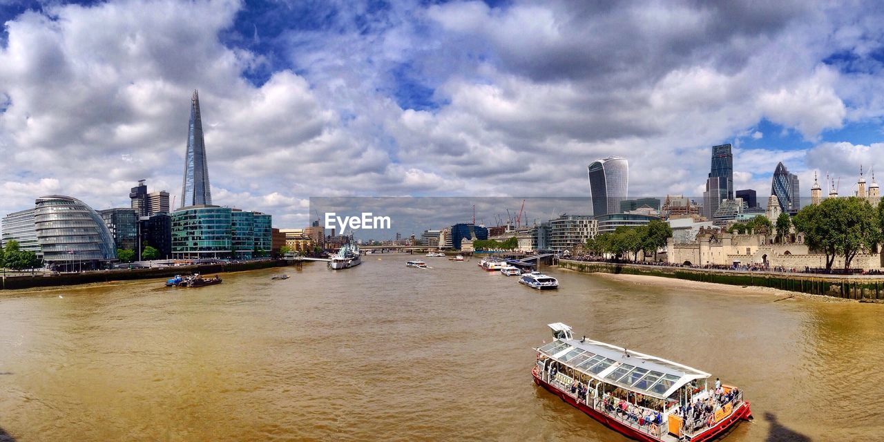 Boats in river with buildings in background