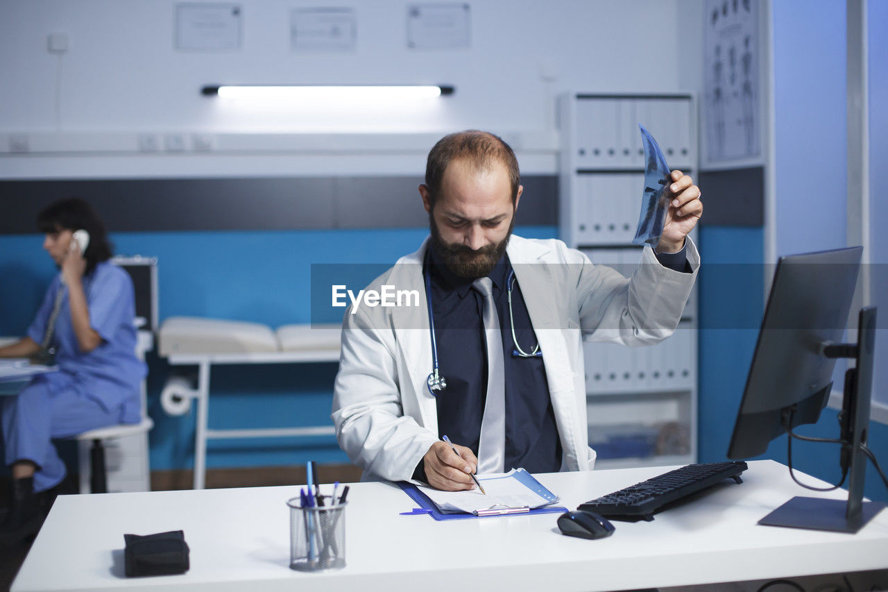 male dentist working at clinic