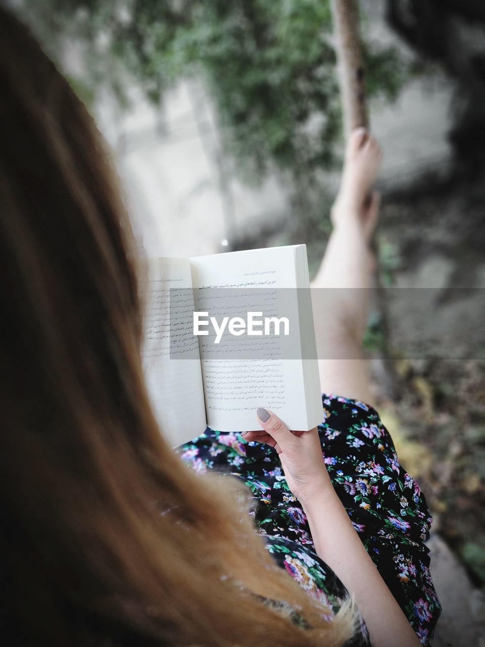 Midsection of woman reading book