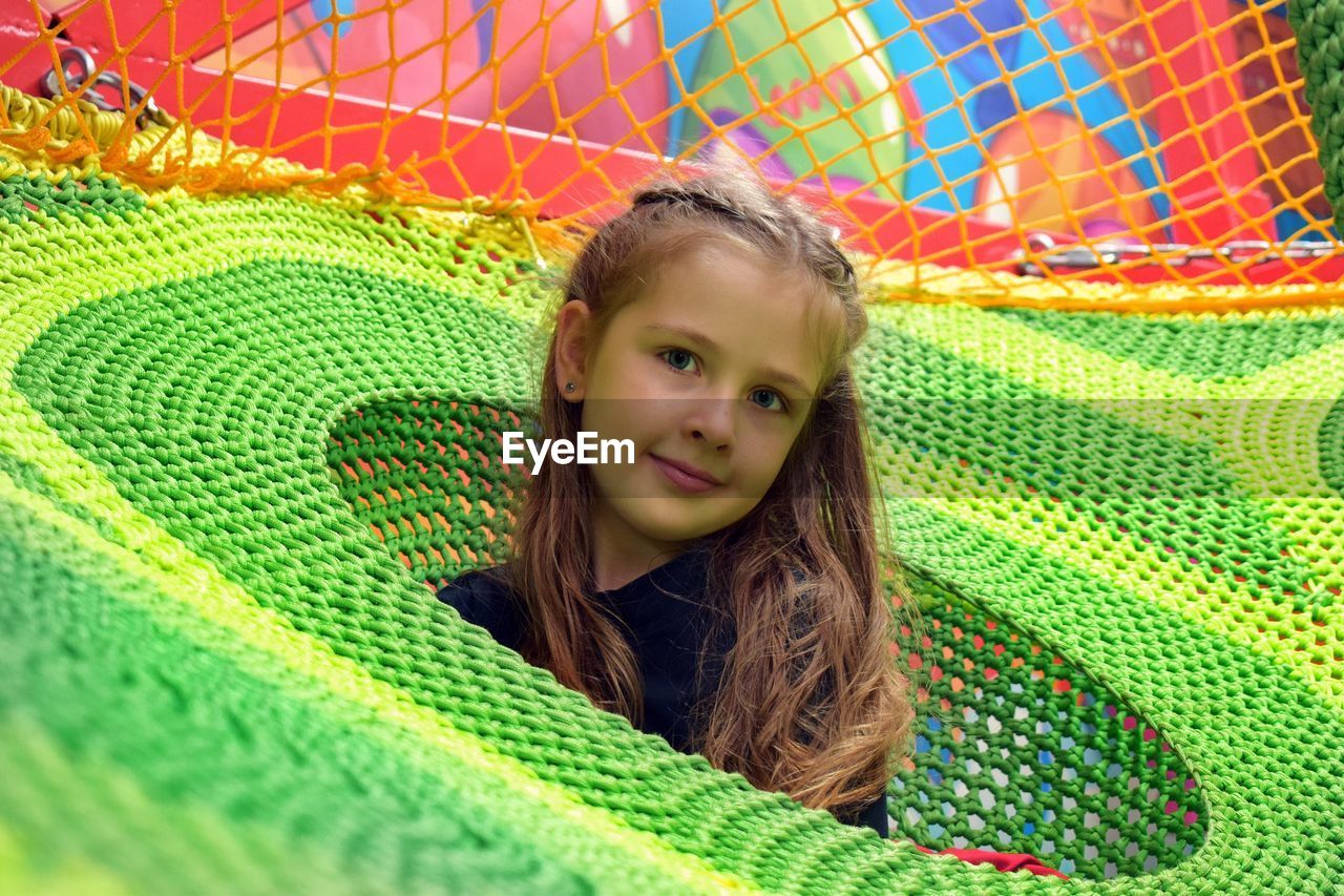 Portrait of girl playing in jungle gym