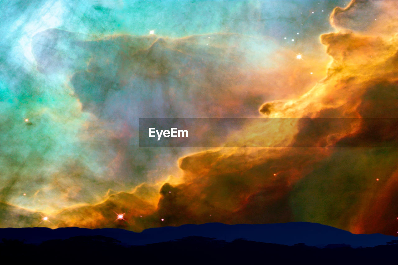 SCENIC VIEW OF DRAMATIC SKY OVER SILHOUETTE MOUNTAIN