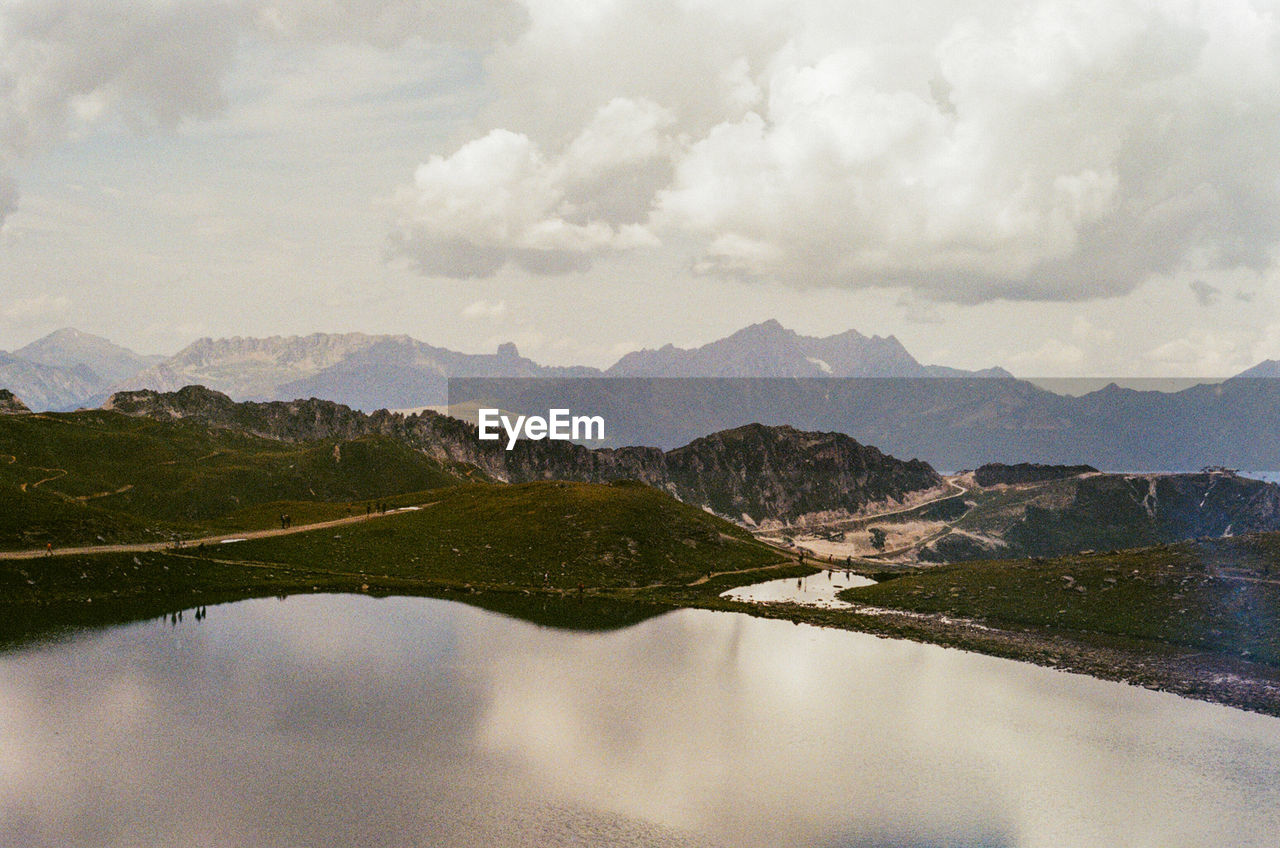 Scenic view of lake and mountains against sky