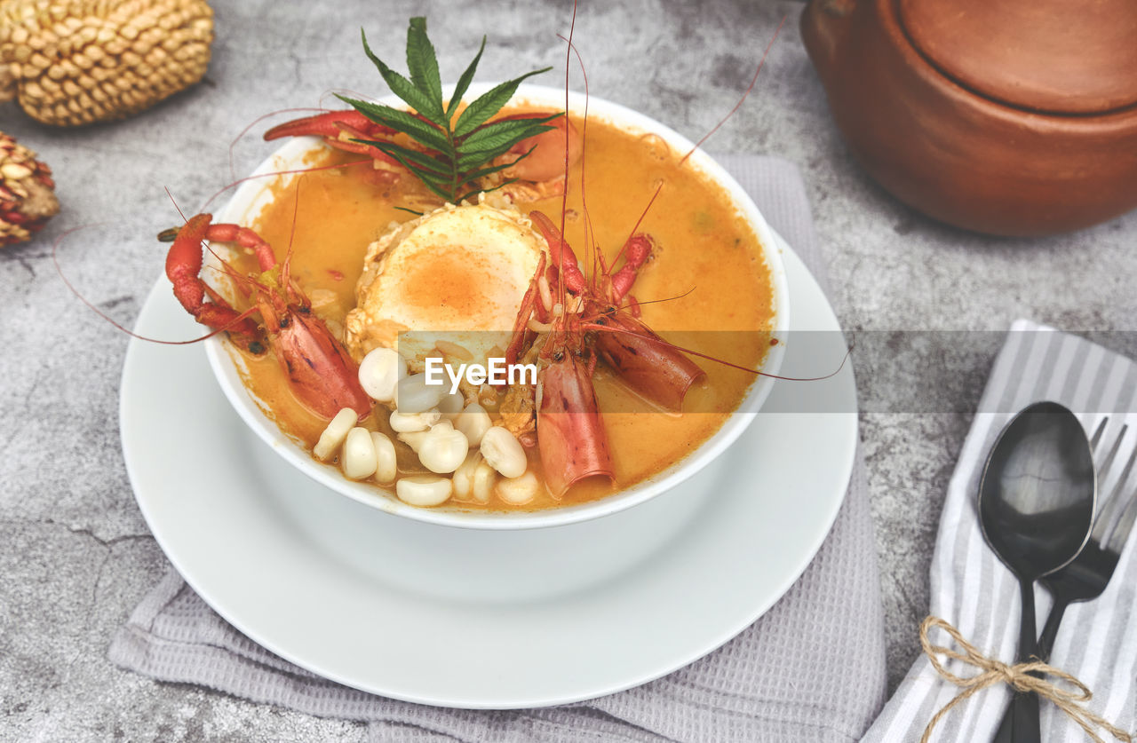 Peruvian food, prawns soup, called chupe de camarones, top view . selective focus