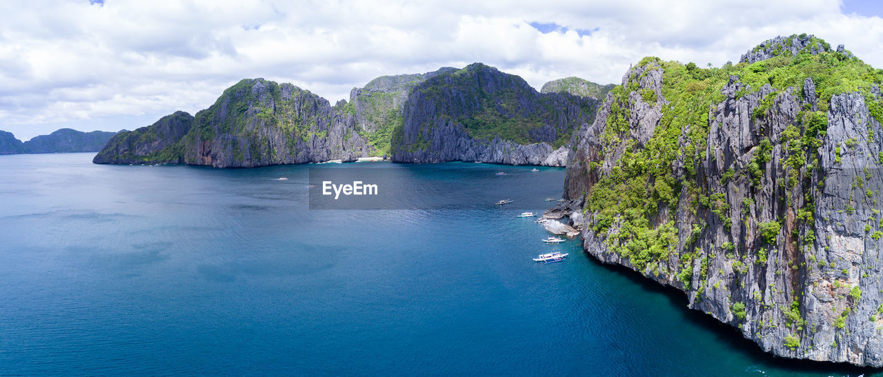 PANORAMIC VIEW OF SEA AND ROCKS AGAINST SKY