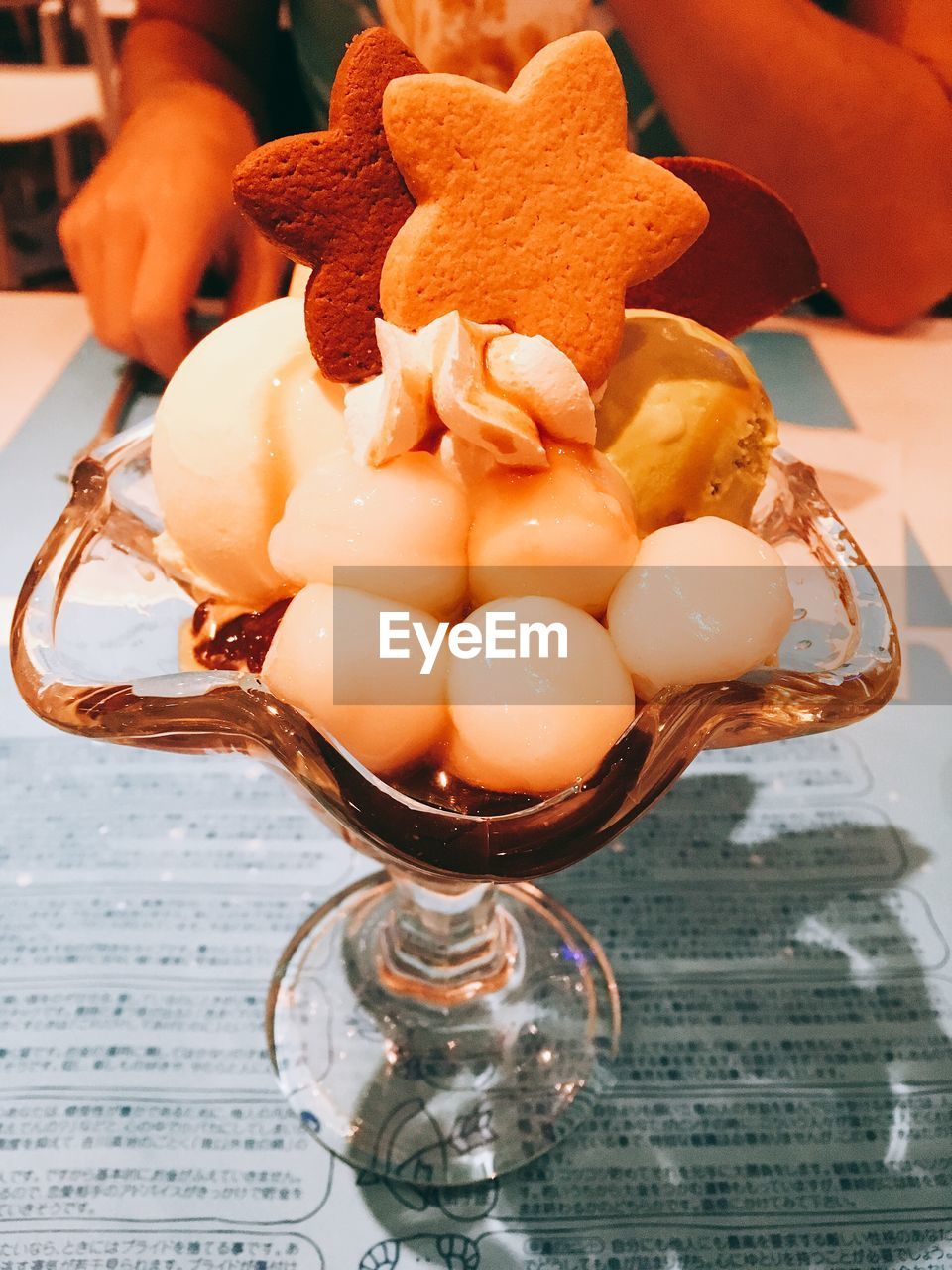 CLOSE-UP OF ICE CREAM WITH SPOON ON TABLE