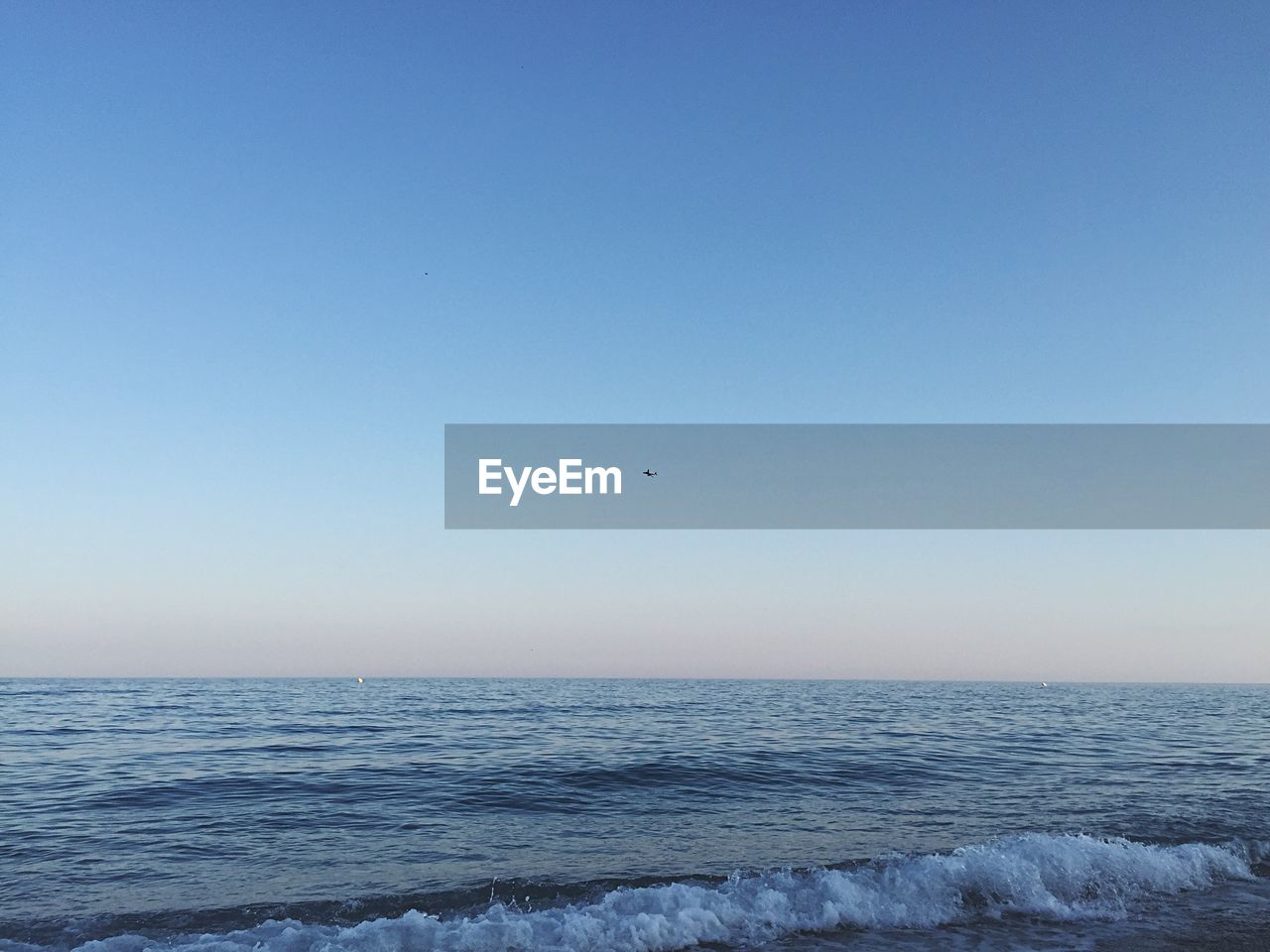 Scenic view of sea against blue sky