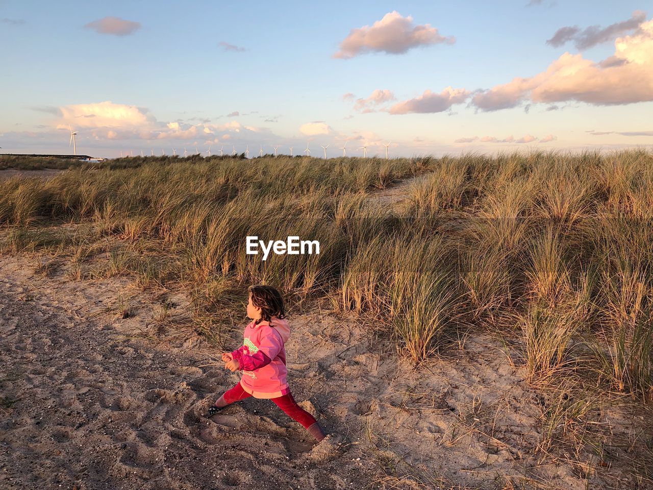 High angle view girl standing with legs apart on field