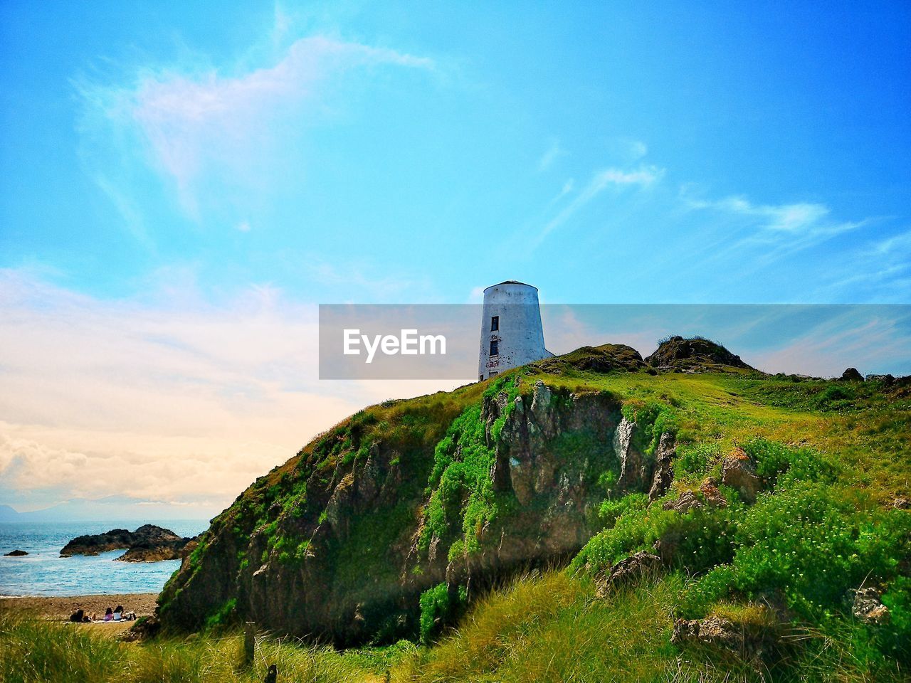 sky, coast, hill, sea, horizon, architecture, land, tower, cloud, nature, built structure, water, environment, landscape, cliff, ocean, travel destinations, scenics - nature, grass, lighthouse, travel, beach, building exterior, no people, plant, rock, blue, beauty in nature, building, guidance, rural area, coastline, outdoors, tourism, shore, history, the past, tranquility, bay, non-urban scene, day, tranquil scene