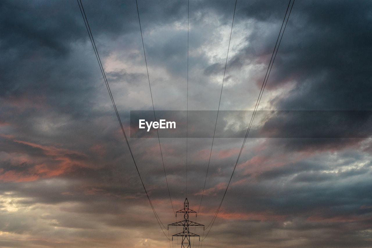 View of electricity pylon. dramatic sky. hochspannungsleitung im sonnenuntergang. nature power