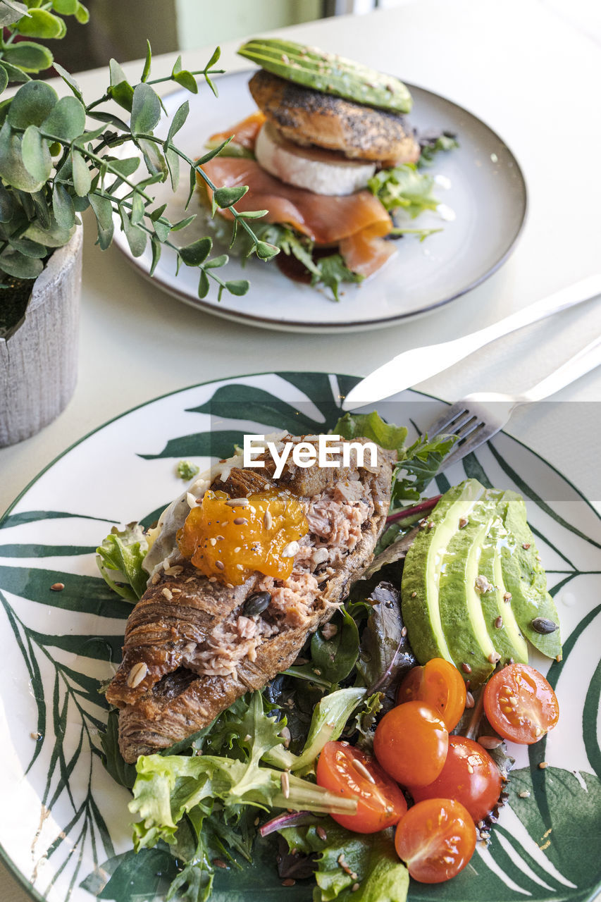 Breakfast plates with croissants with avocado and salad. brunch