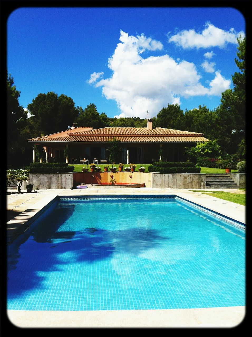 VIEW OF SWIMMING POOL AGAINST CALM BLUE SEA