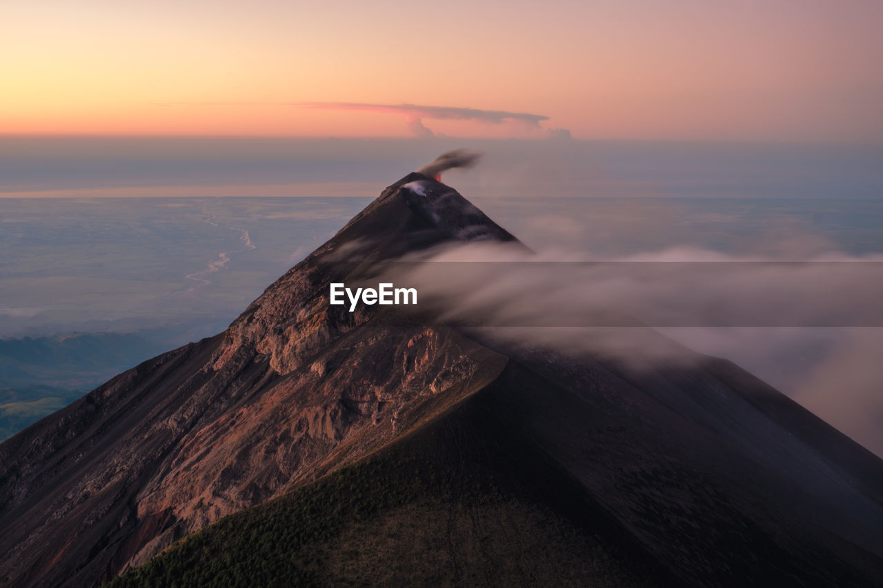 Unforgettable sunset over the volcano fuego in guatemala, took after a cold night on the acatenango