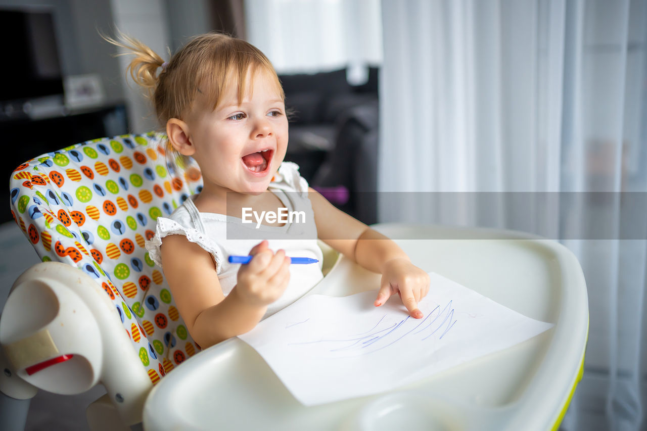 portrait of cute baby boy with daughter at home