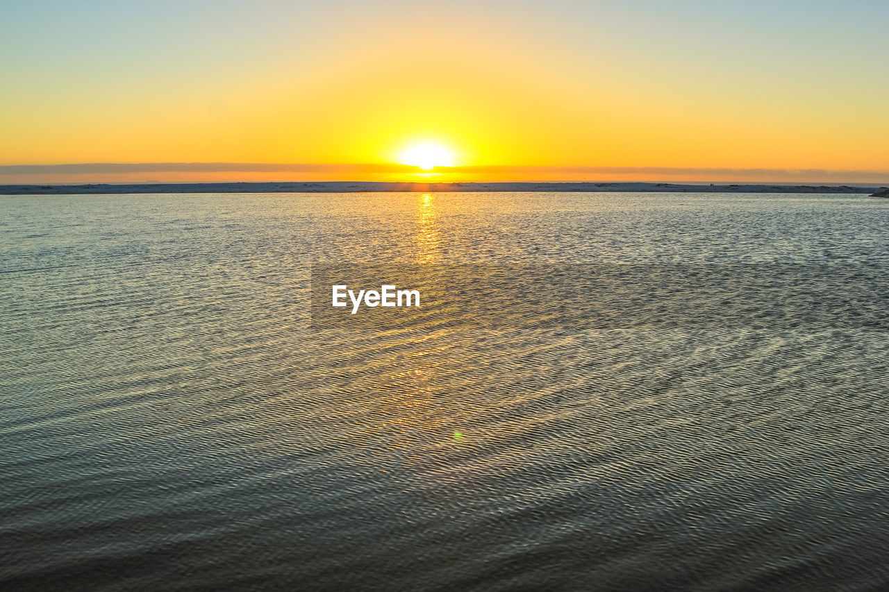 Scenic view of sea against clear sky during sunset