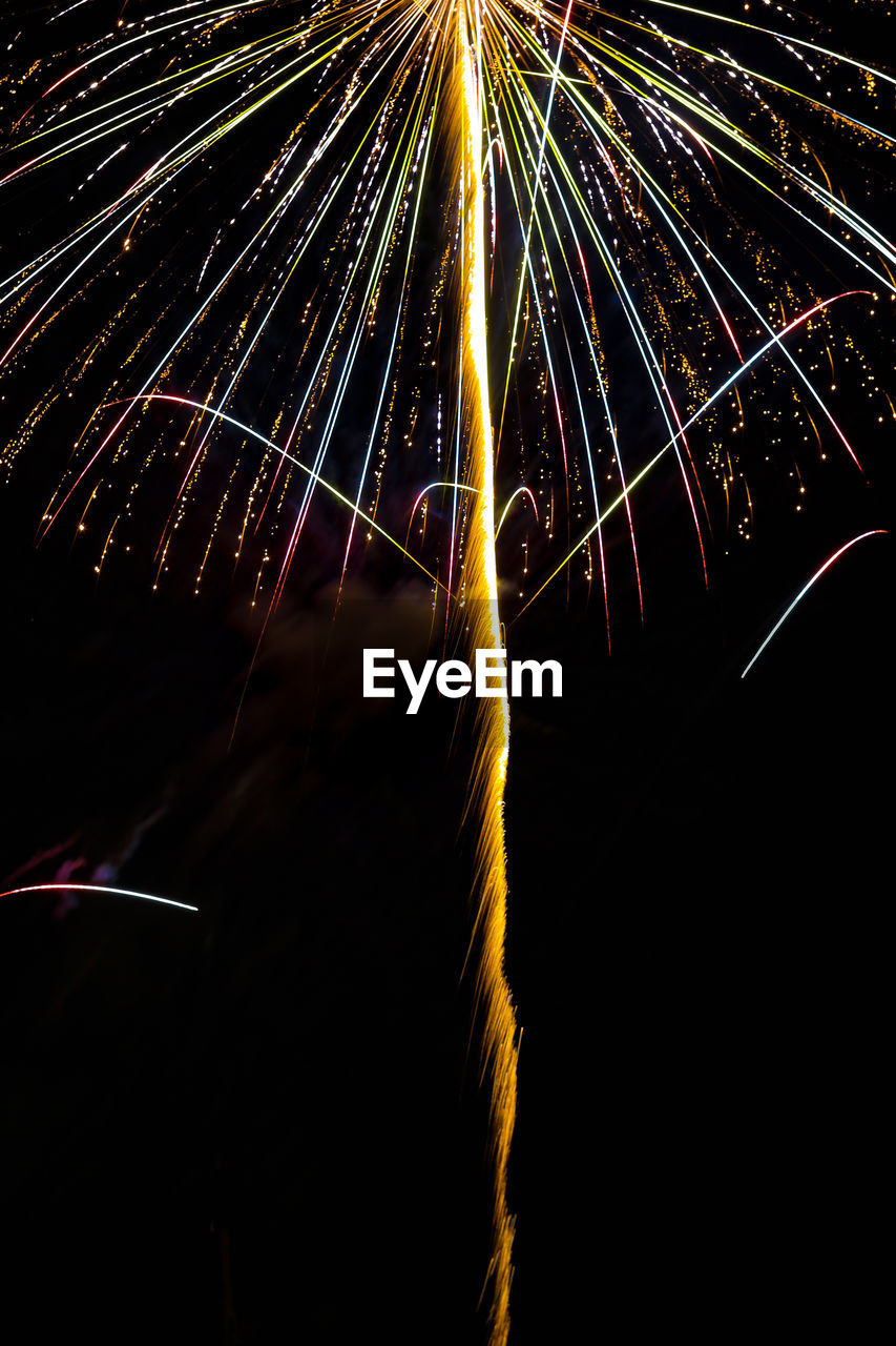 Low angle view of firework display at night