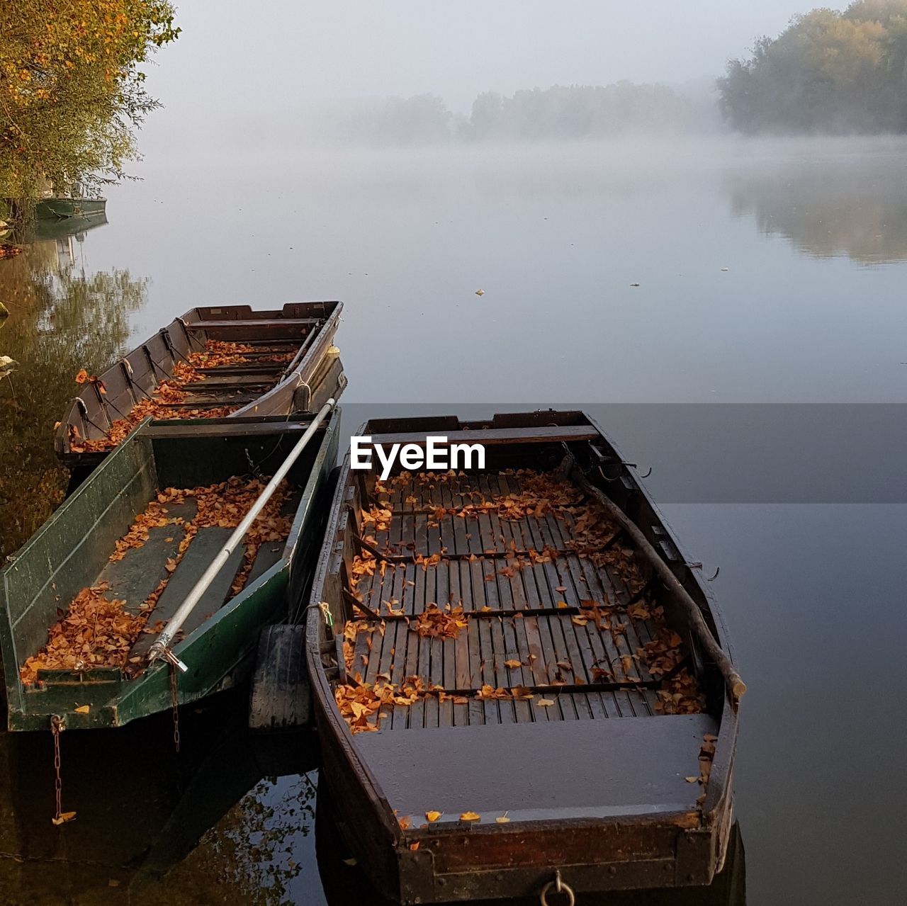 High angle view of boats moored in lake during foggy weather