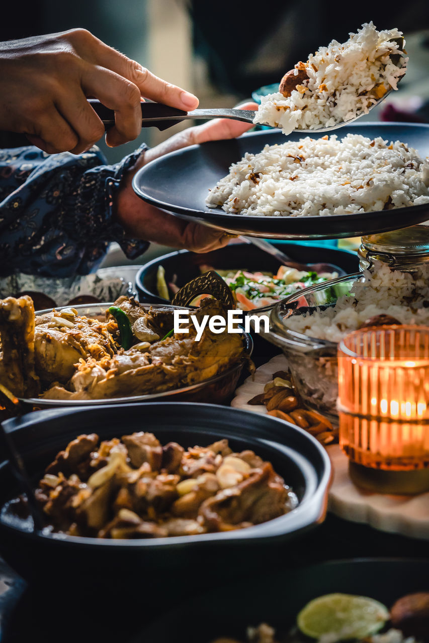Cropped hand preparing food on table