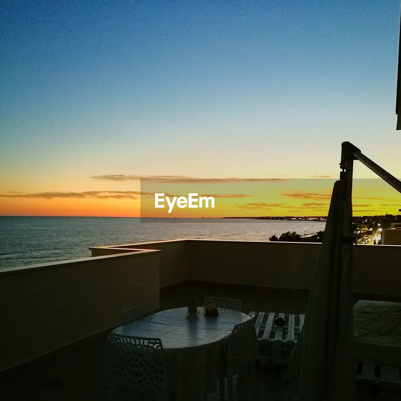 SCENIC VIEW OF CALM BEACH AT SUNSET