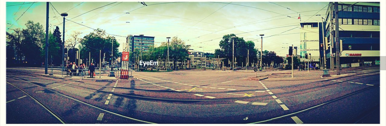 EMPTY ROAD WITH TREES IN BACKGROUND