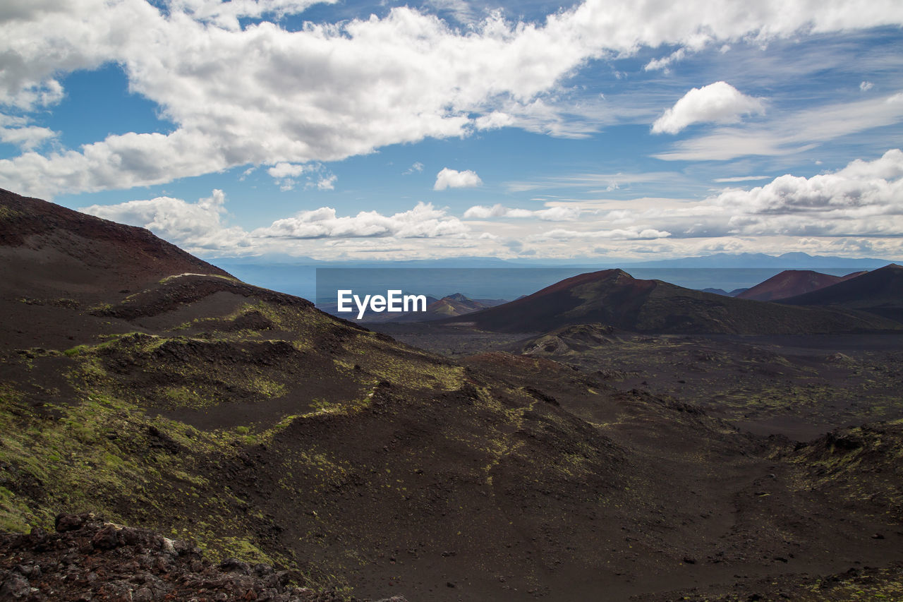 Scenic view of mountains against cloudy sky