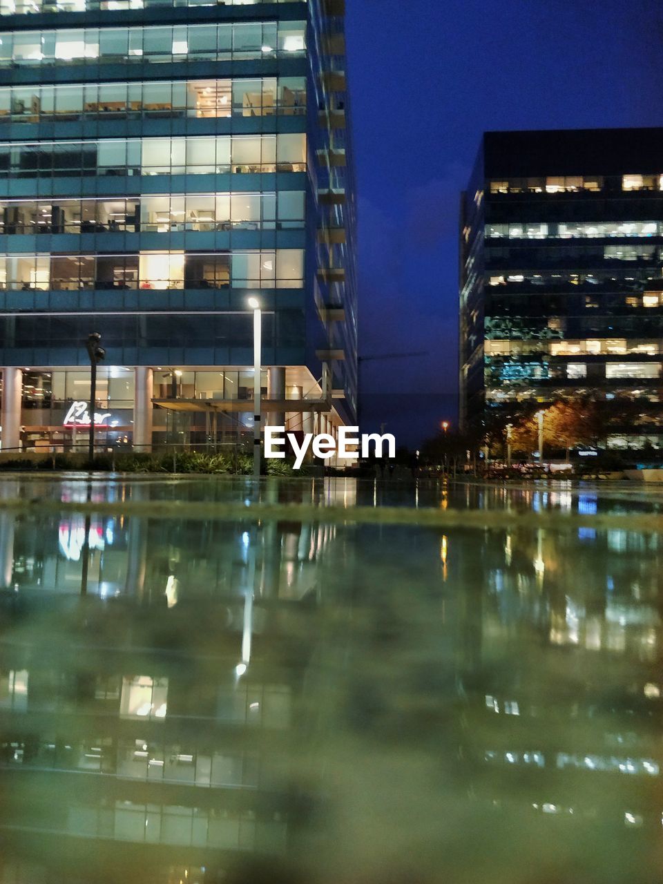 Reflection of illuminated buildings in city at night