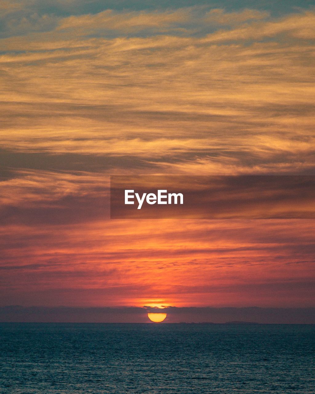 Scenic view of sea against orange sky