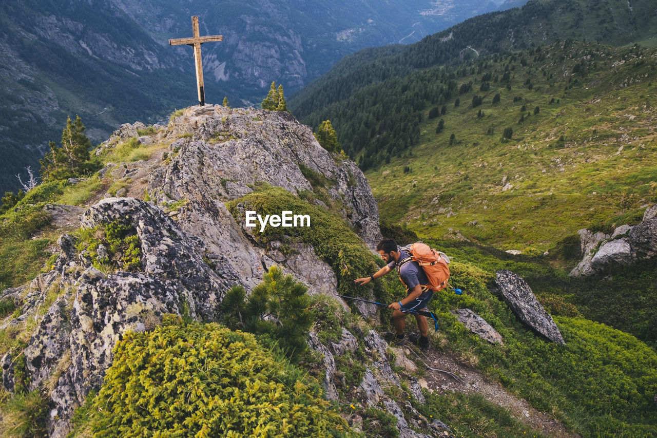 Young hiker reaches the summit of aiguillette des posettes, chamonix.