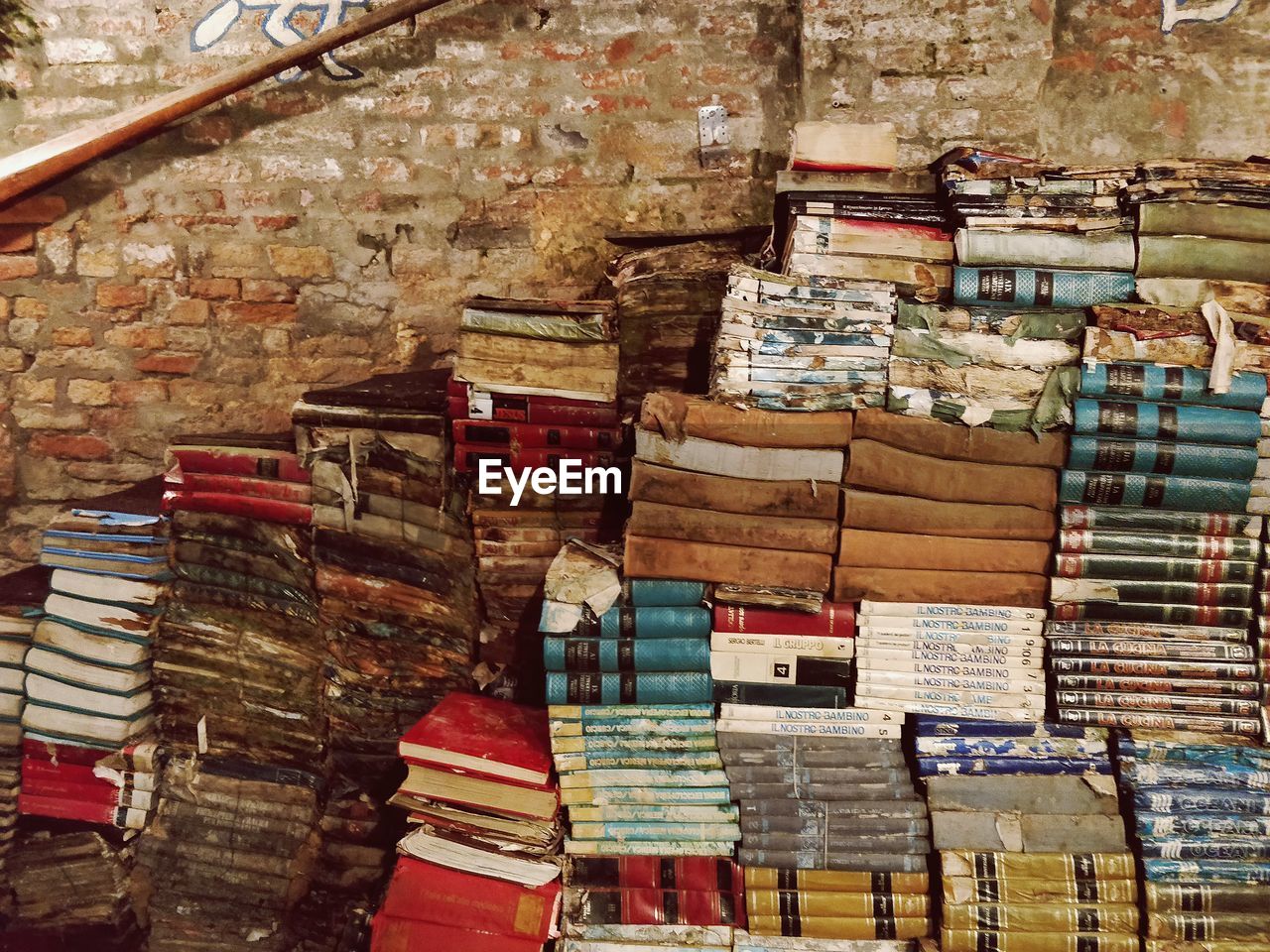 Stack of old books against wall