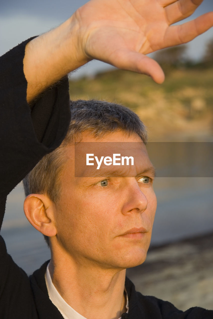 Close-up of man practicing tai chi at beach