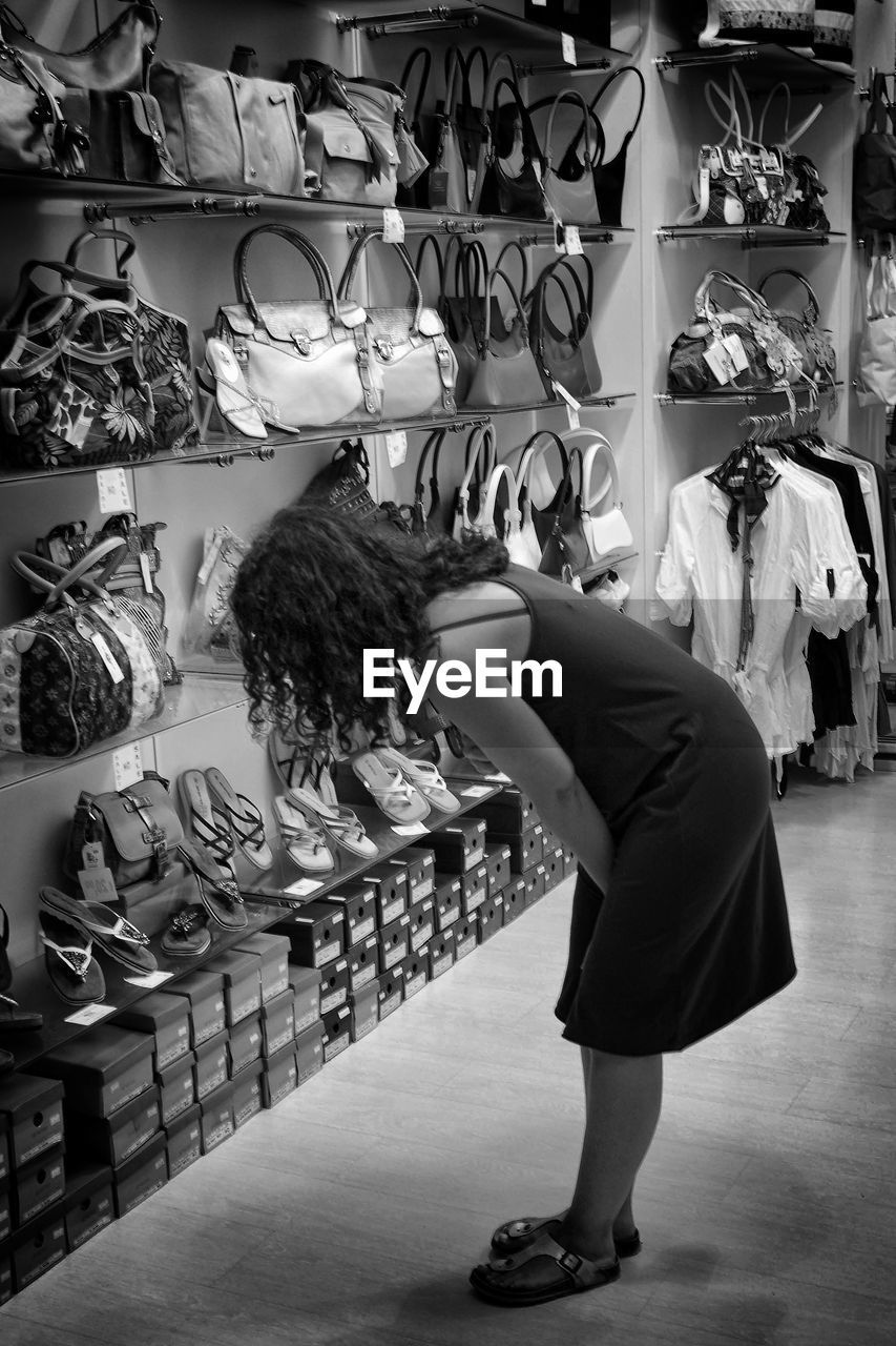 WOMAN STANDING AT MARKET