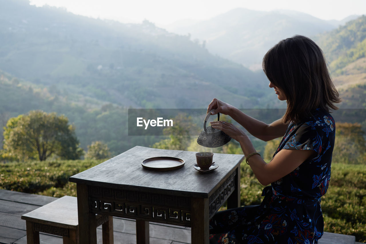 Woman drinking tea in garden