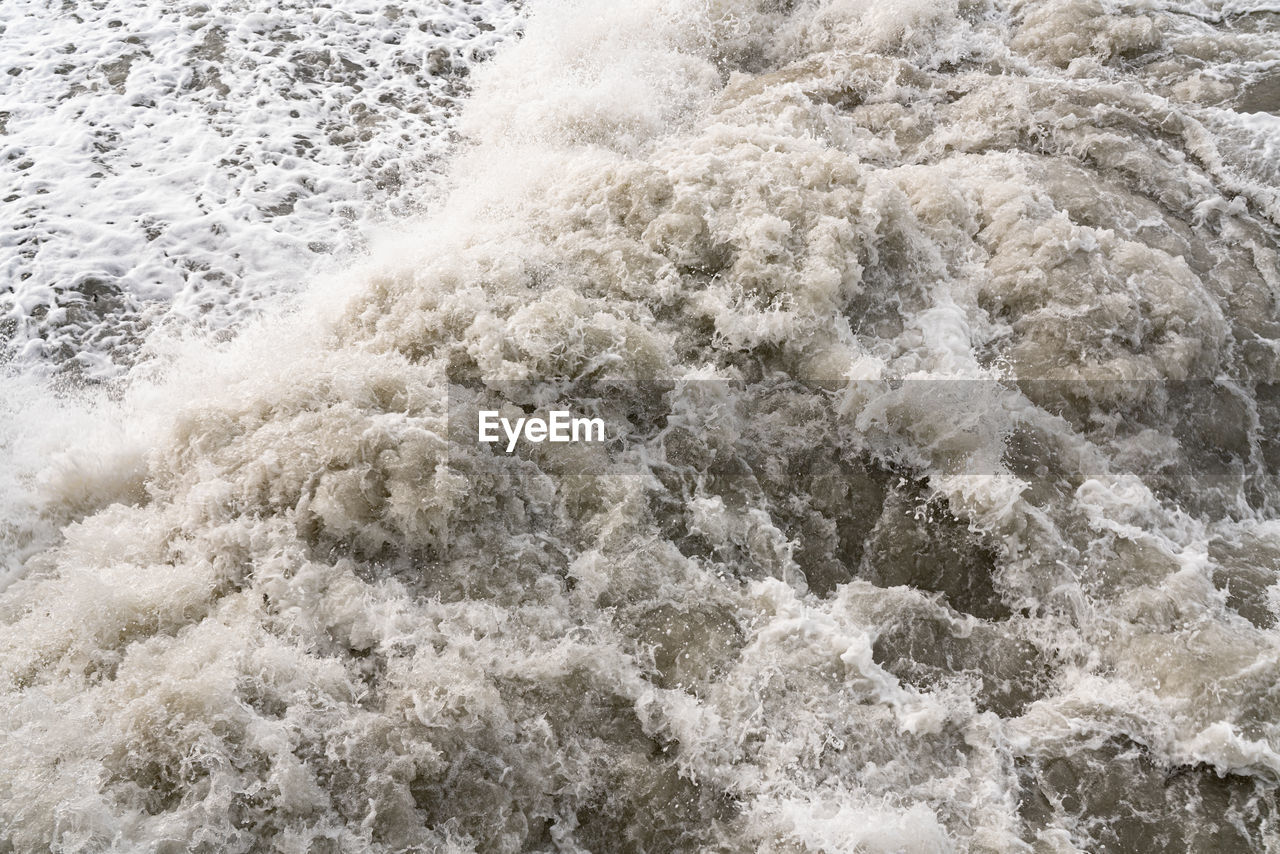 HIGH ANGLE VIEW OF WATER FLOWING THROUGH SEA