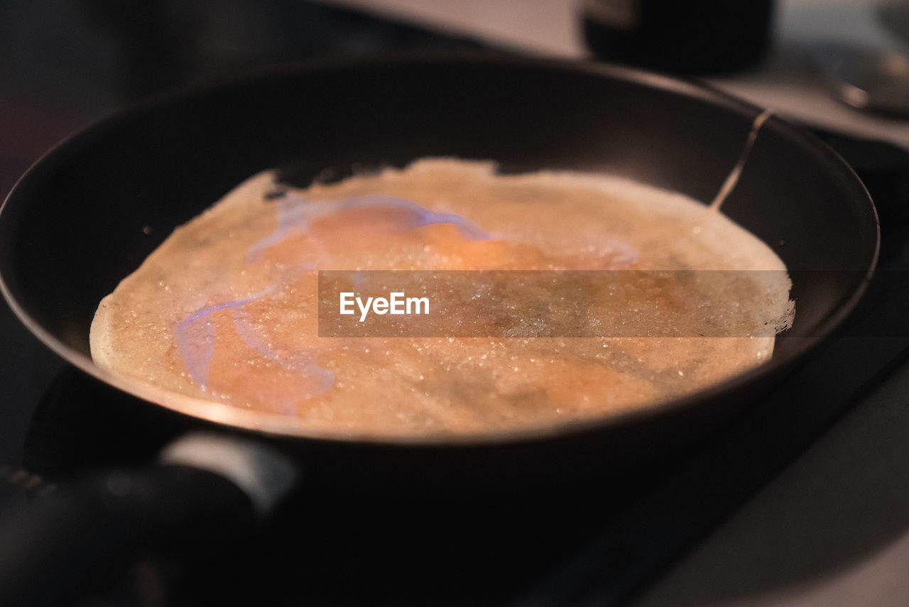 Close-up of crepe in frying pan on stove