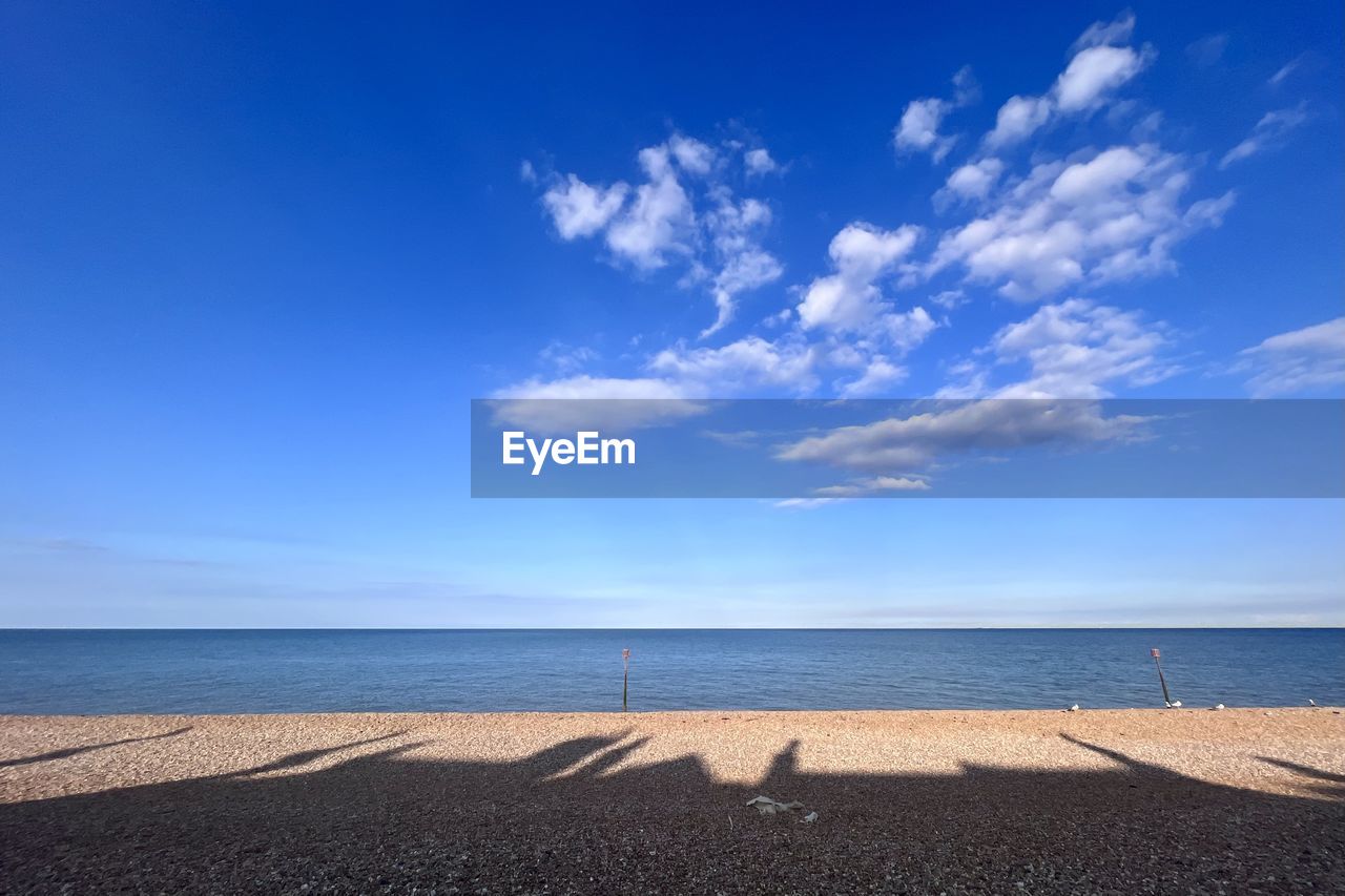 sky, horizon, sea, water, beach, land, blue, horizon over water, scenics - nature, cloud, nature, beauty in nature, ocean, shore, body of water, tranquility, sand, tranquil scene, sunlight, coast, environment, travel destinations, travel, holiday, summer, no people, day, landscape, urban skyline, outdoors, vacation, trip, idyllic, tourism, coastline, seascape, wave, sunny, dusk, water's edge, clear sky, copy space, bay, non-urban scene