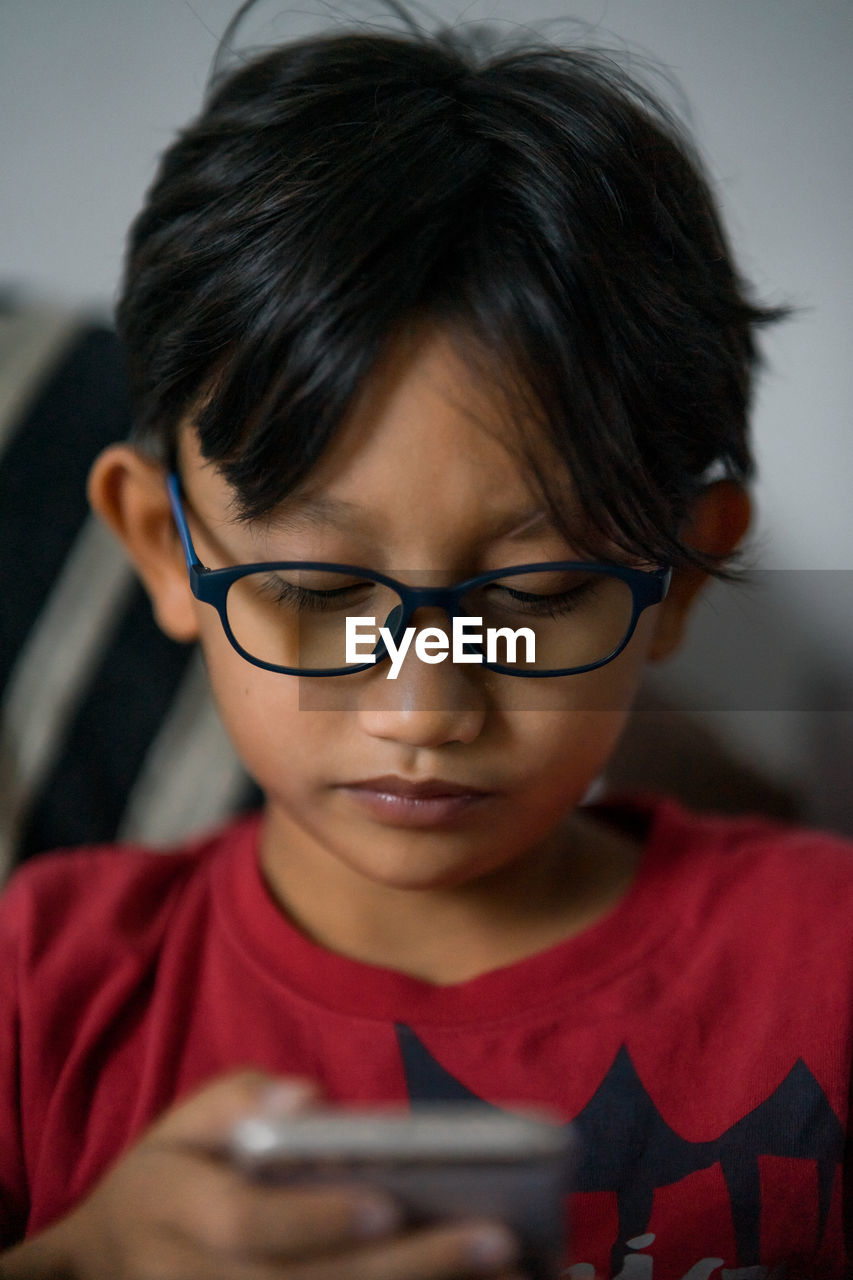 Close-up of boy using smartphone