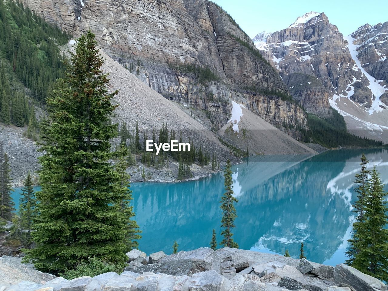 Scenic view of moraine lake by mountains