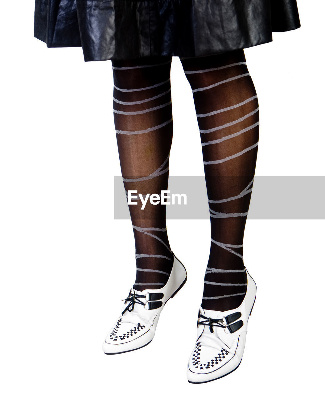 Low section of woman wearing stockings against white background