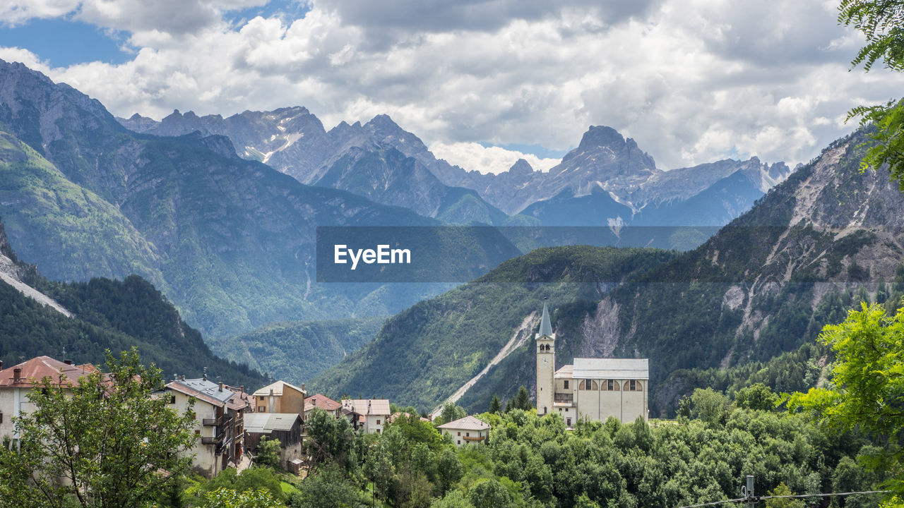 Houses and mountains against sky
