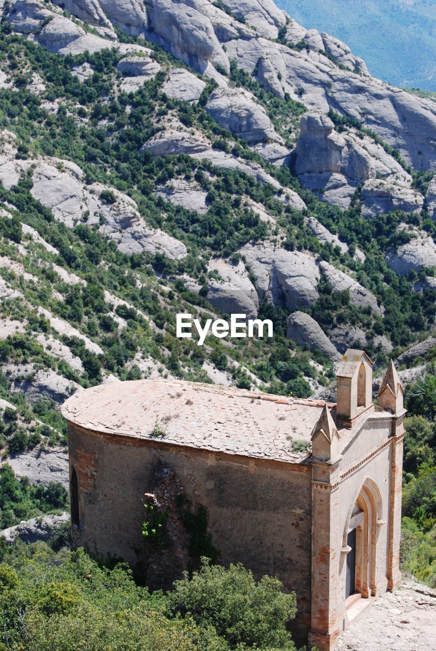 Built structure on landscape against mountain