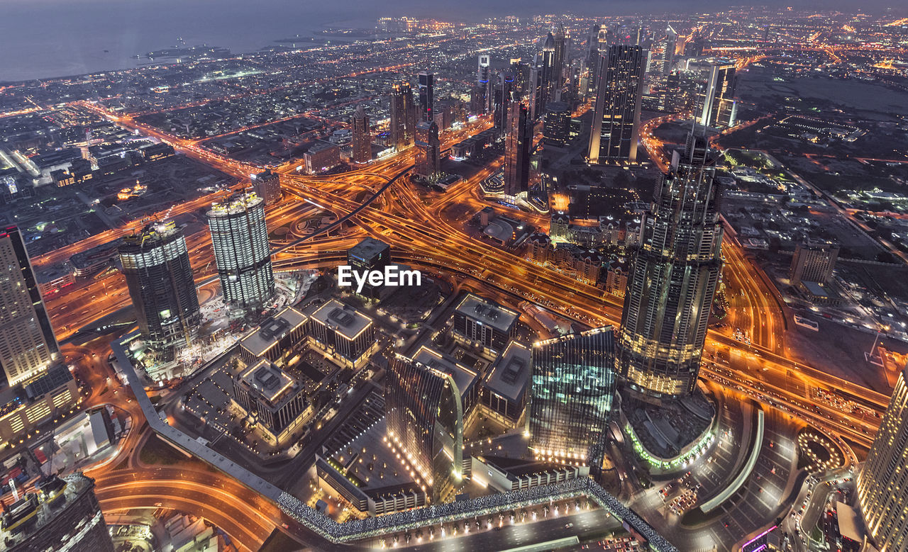 Aerial view of illuminated buildings in city at night