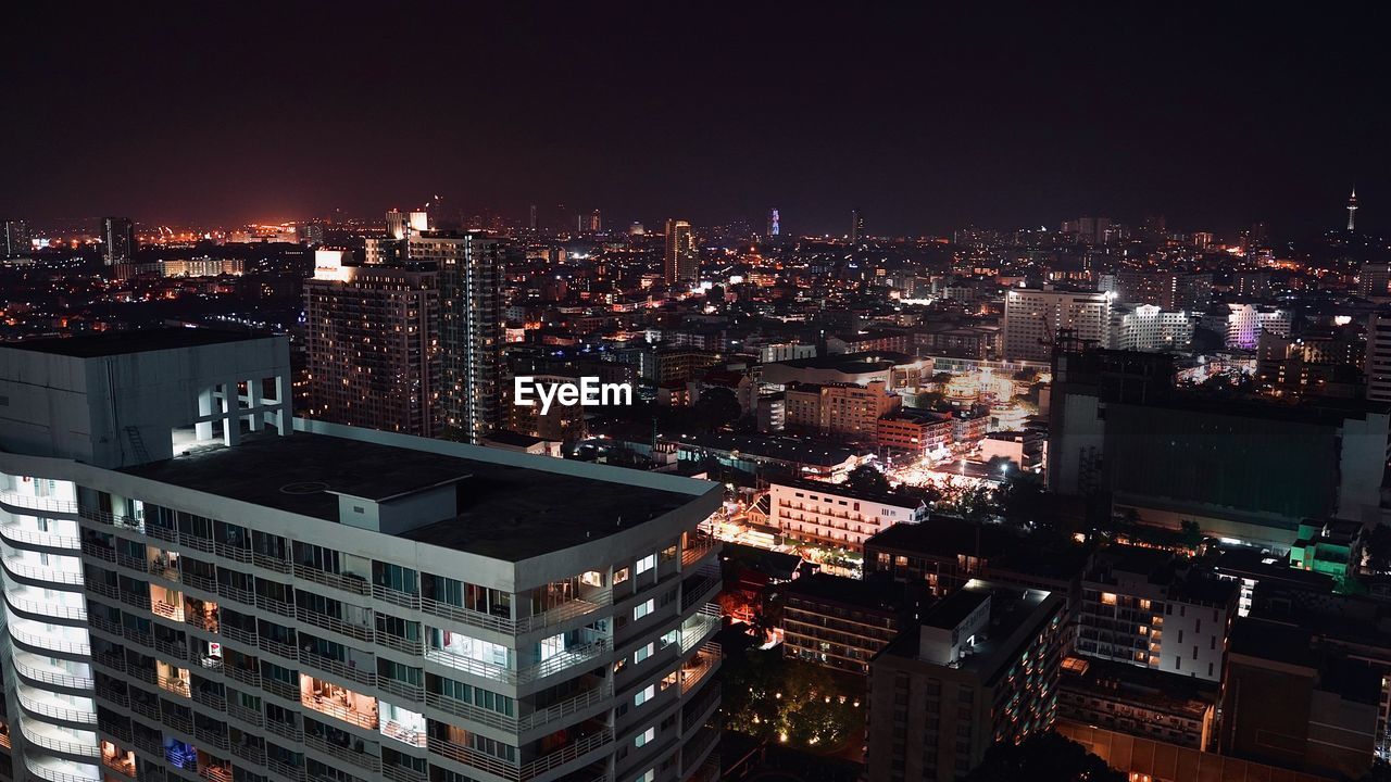 High angle view of illuminated buildings in city at night