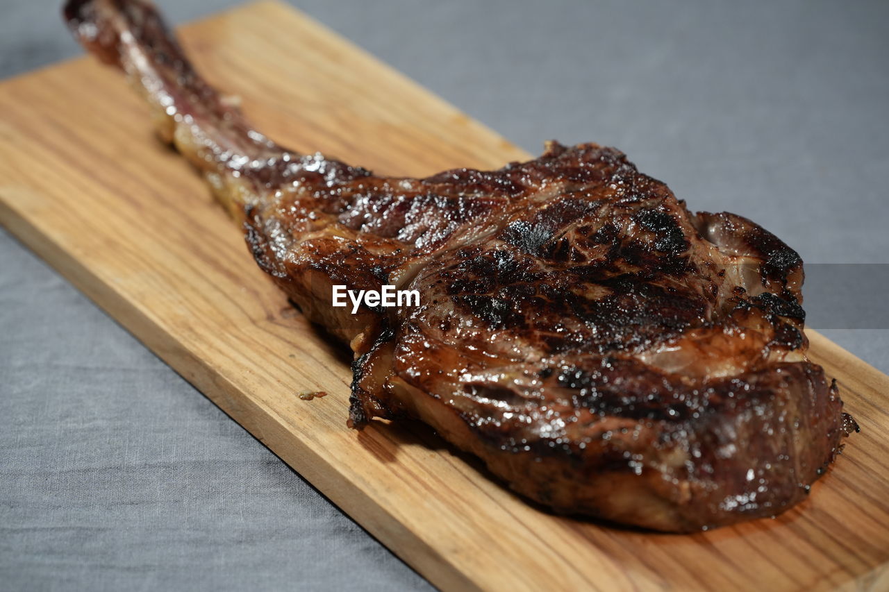 Tomahawk steak on wooden board